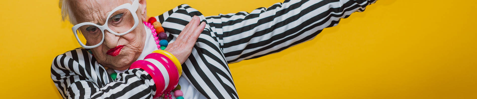 alt="hoofd oudere dame hip gekleed maakt dansend gebaar"